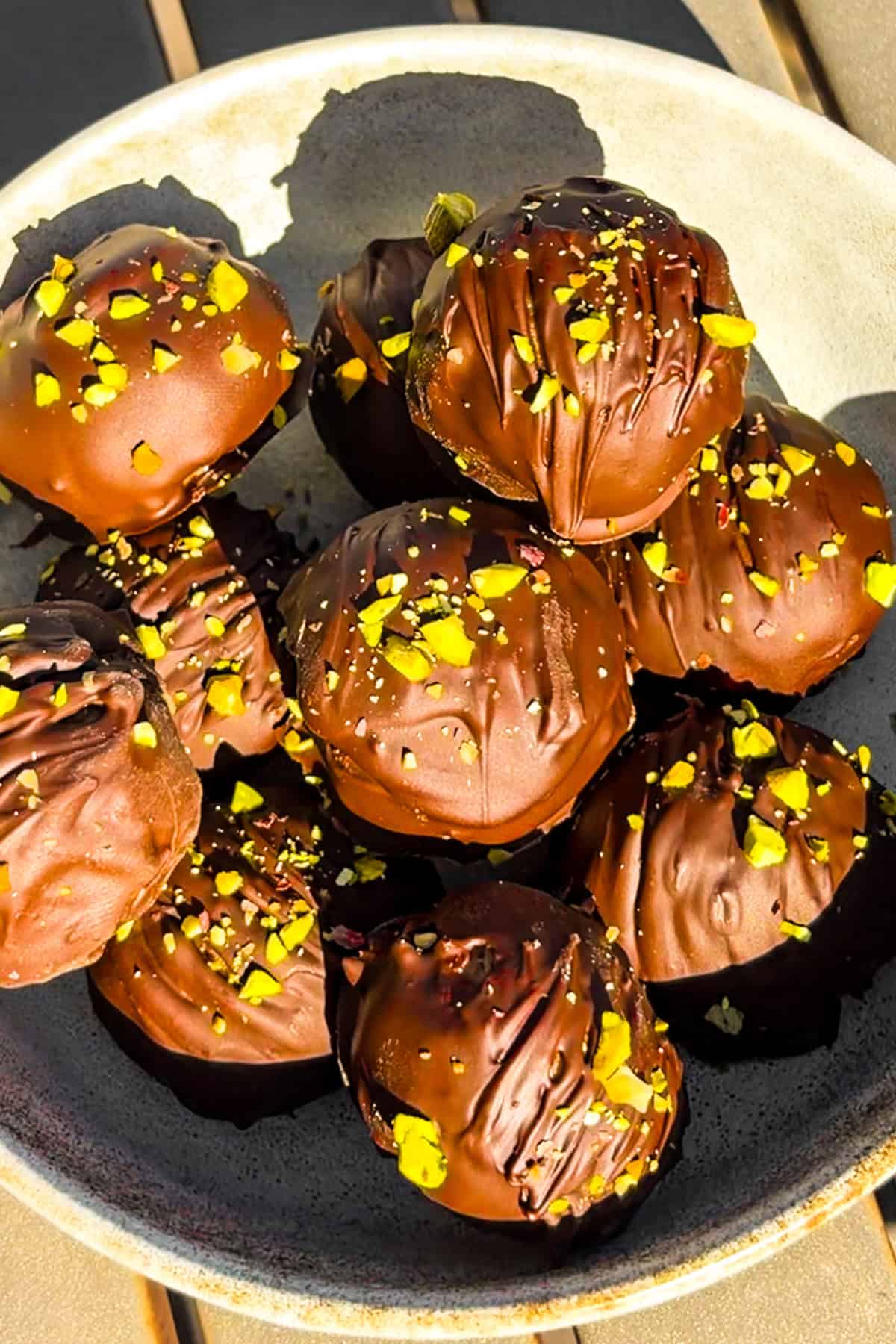 Peanut butter chocolate pistachio balls in a bowl.