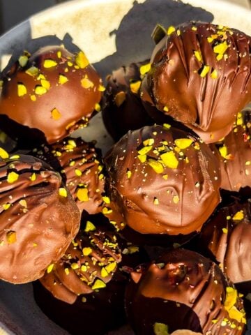 Peanut butter chocolate pistachio balls in a bowl.