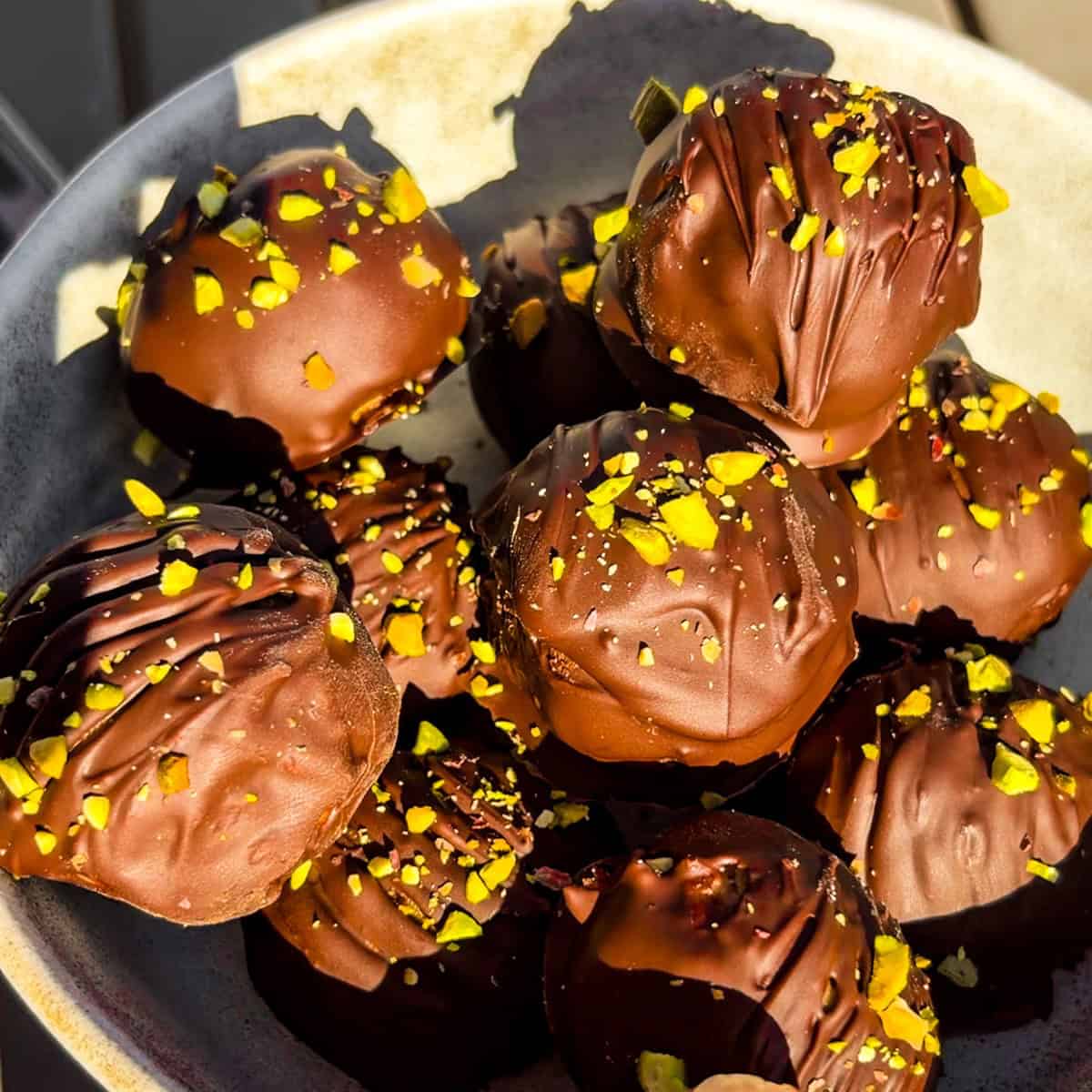 Peanut butter chocolate pistachio balls in a bowl.