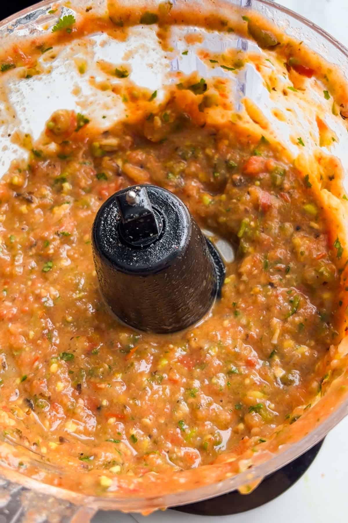 Tomatoes, jalapeños, garlic, onions, avocado, and salt blended in a food processor.