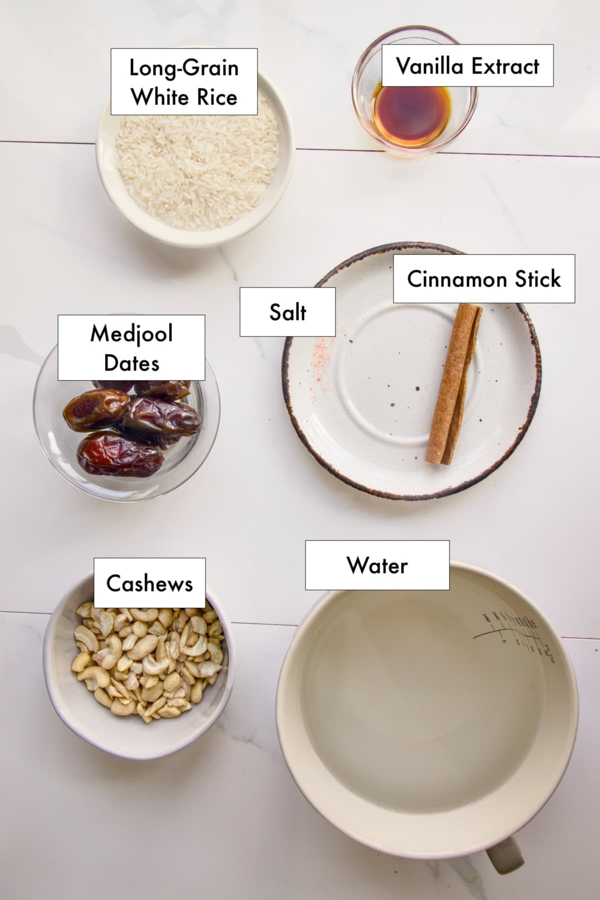 All ingredients needed to make vegan horchata in bowls laid out on a counter.