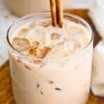 Vegan horchata (Mexican rice milk) in a glass topped with a cinnamon stick.