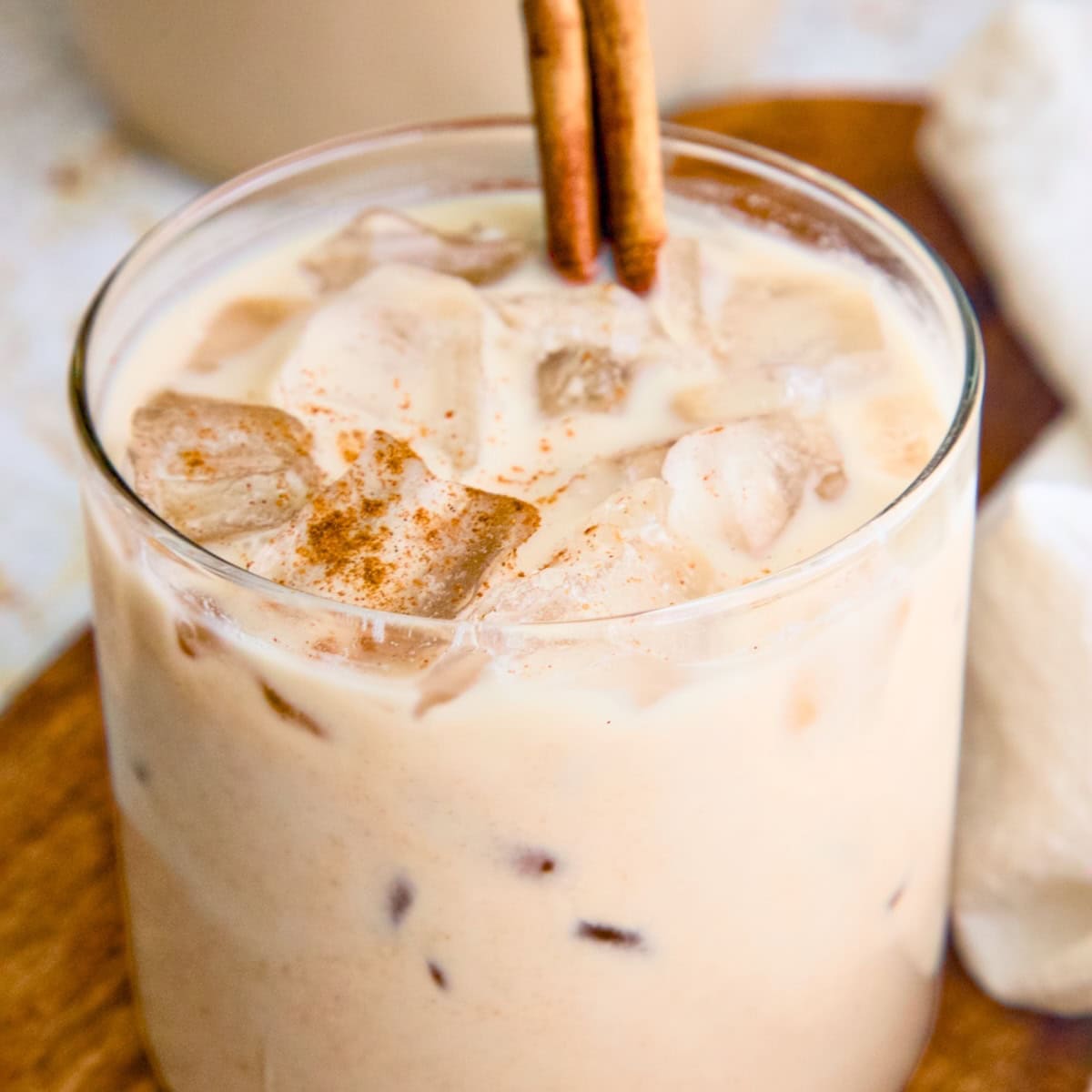 Vegan horchata (Mexican rice milk) in a glass topped with a cinnamon stick.