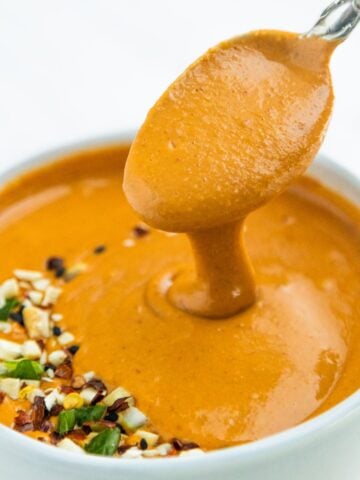 Asian peanut sauce in a bowl with a spoon.