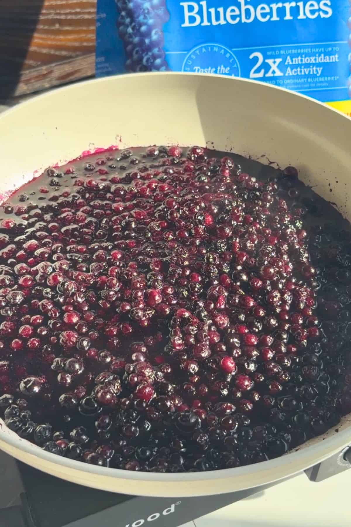 Blueberry compote bubbling in a pan.