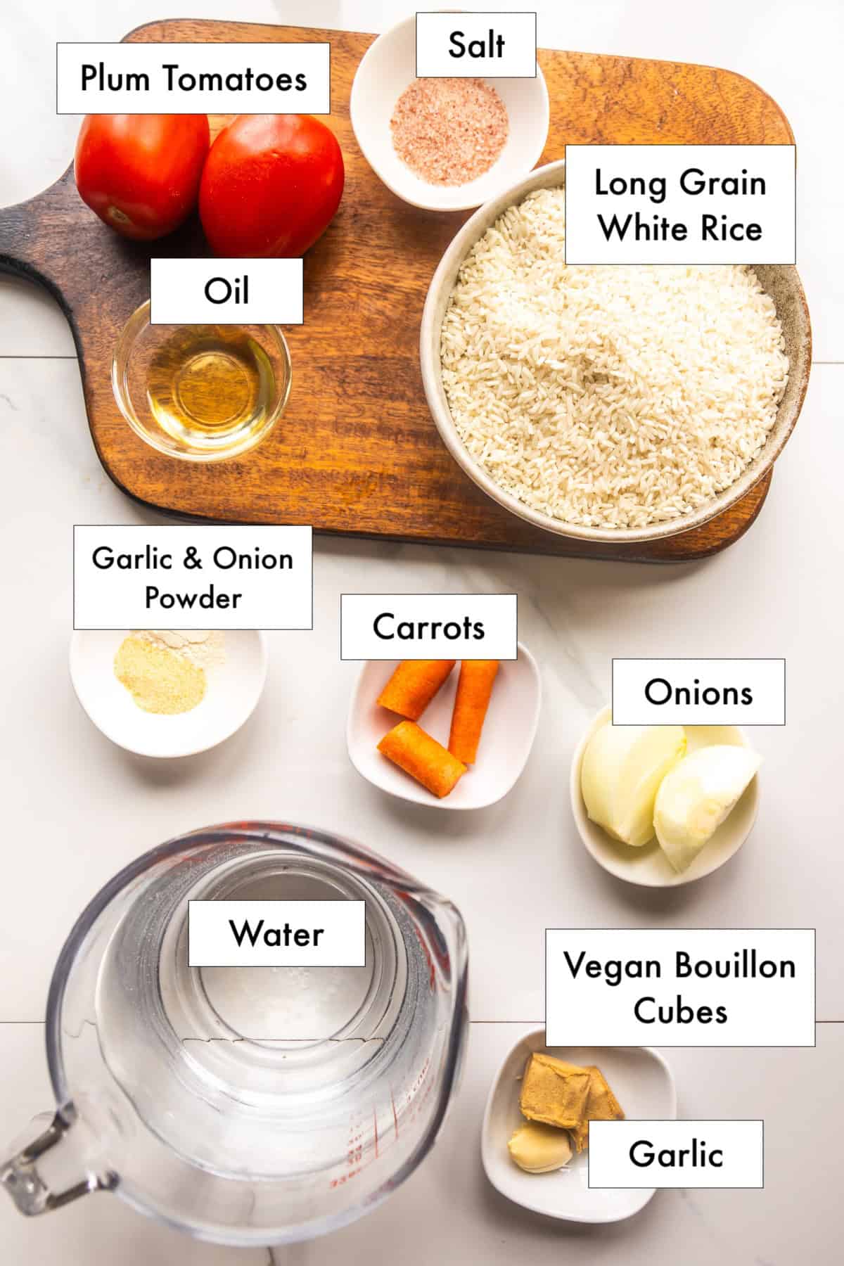 All ingredients needed to make Mexican rice for tacos (simple Mexican rice) in bowls on a counter.