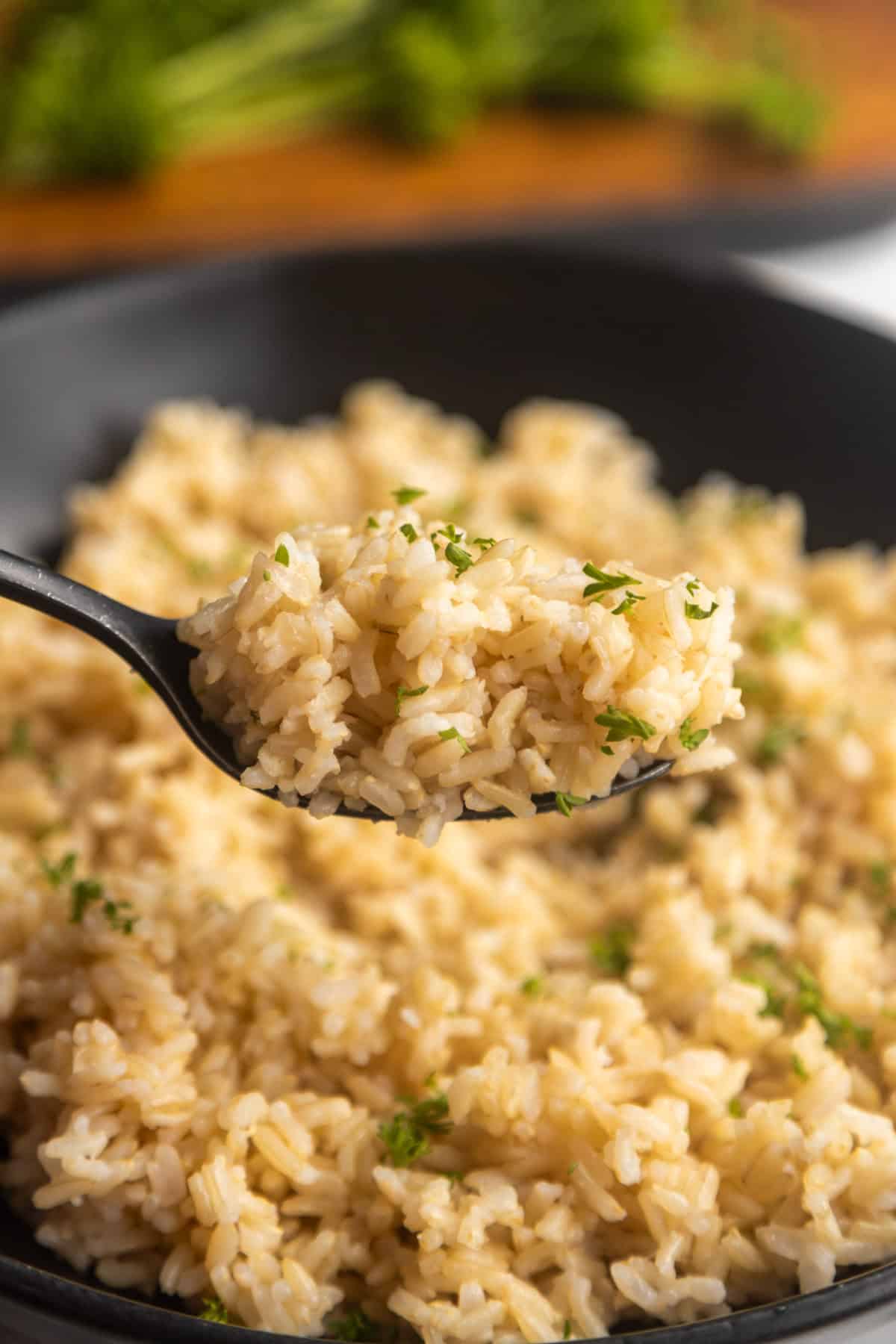 Spoon holding up homemade brown rice.