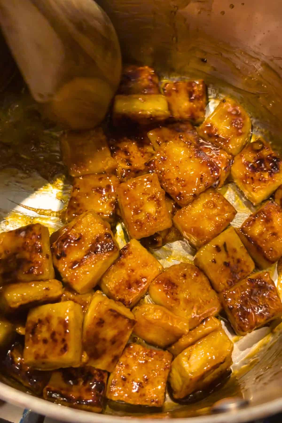 Sticky tofu (crispy maple glazed tofu) in a pan.