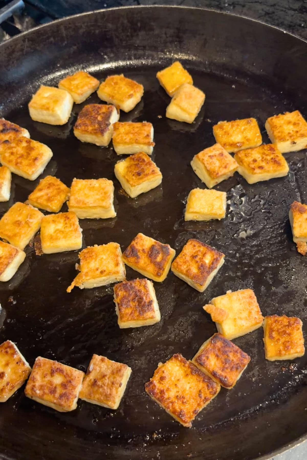 Tofu pan frying in a pan.