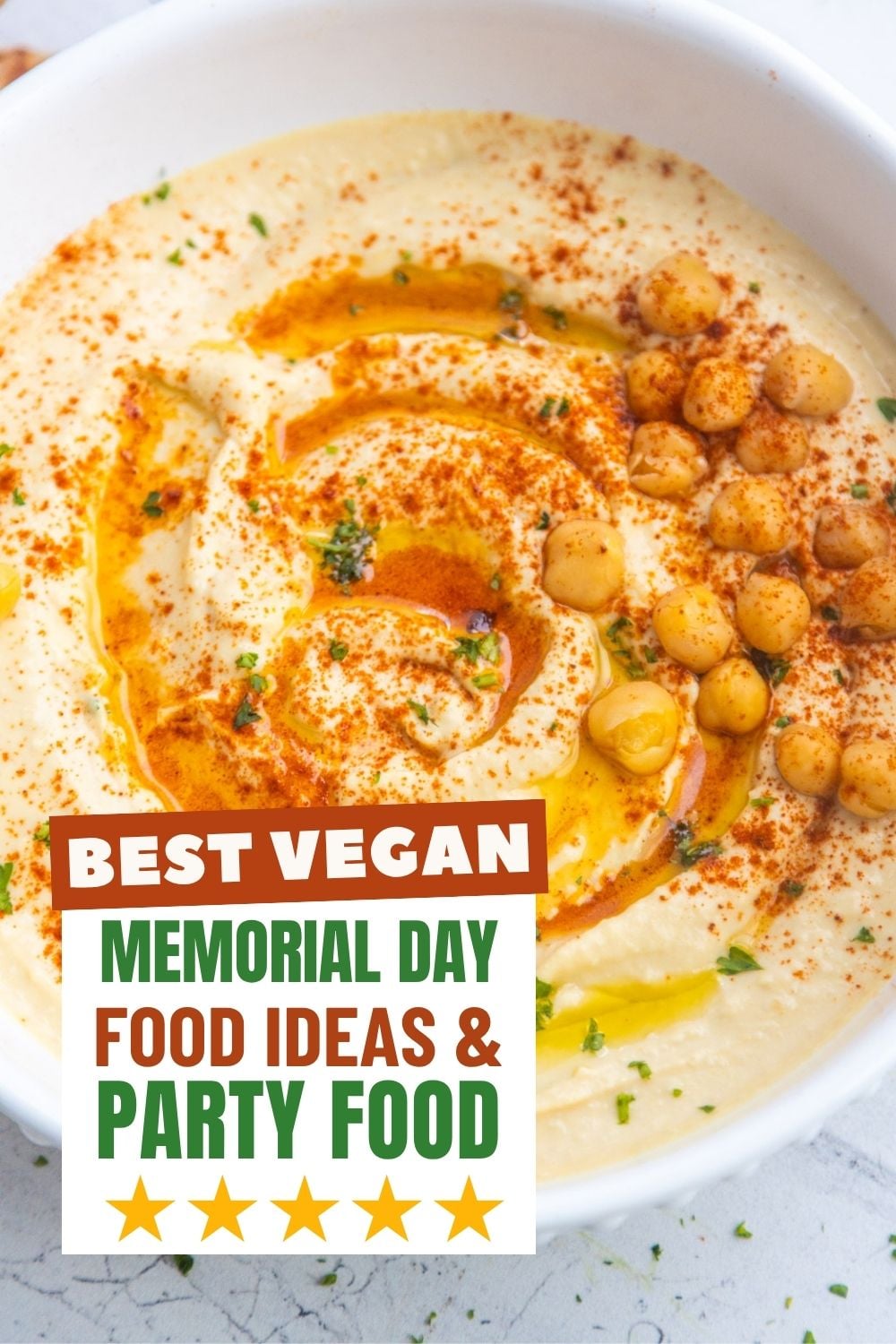 Homemade hummus in a bowl with pita bread on the side.