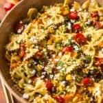 Southwest pasta salad in a bowl with salad spoons on the side.