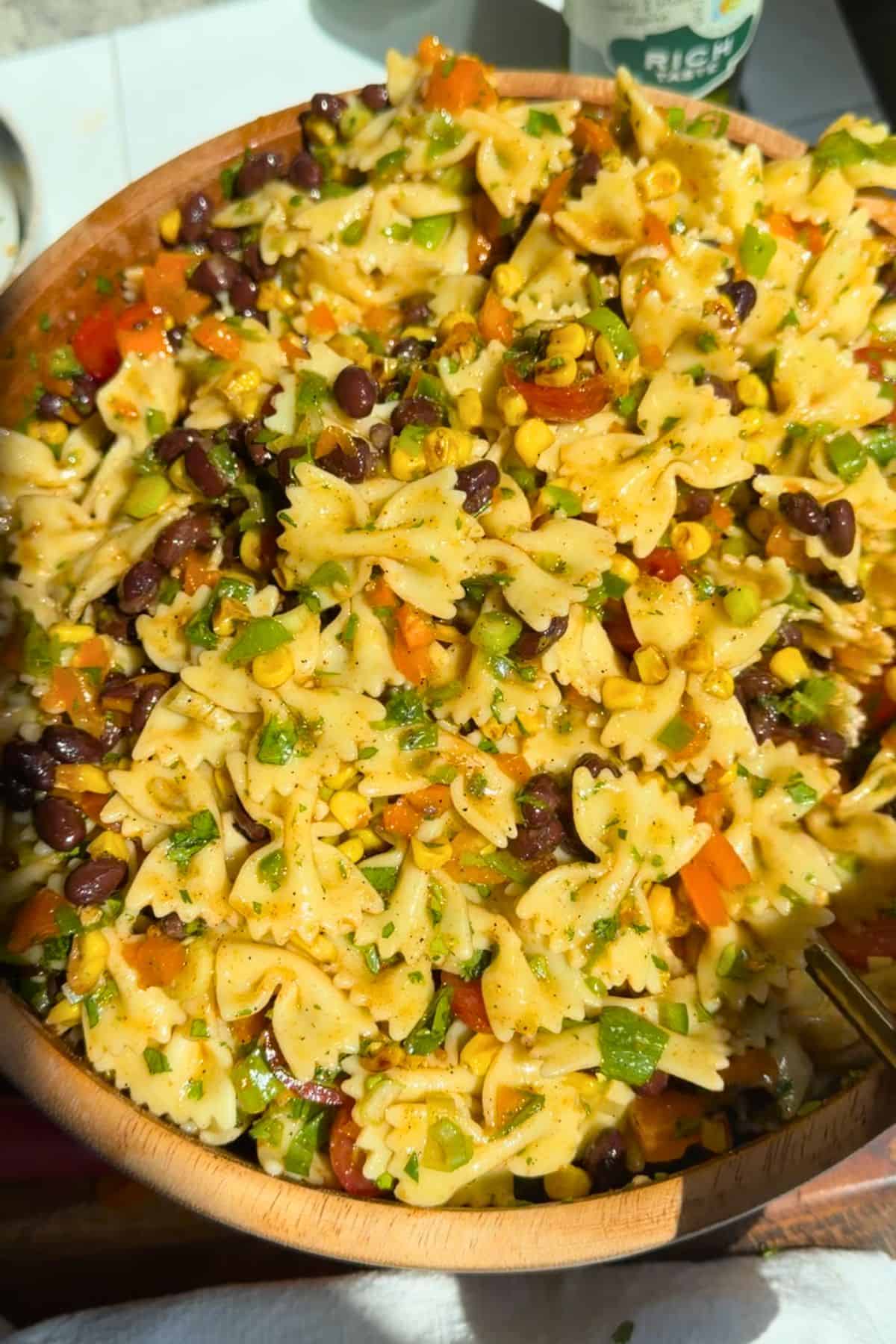 Finished southwest pasta salad in a wooden salad bowl.