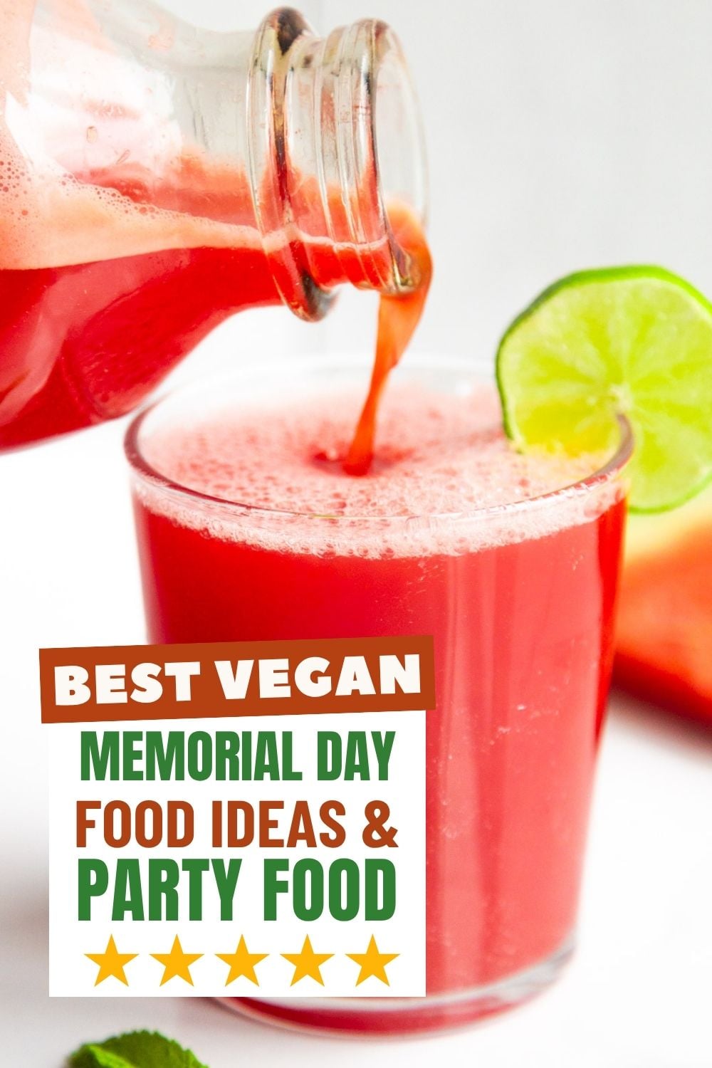 Watermelon juice pouring into a glass with a lime wedge.