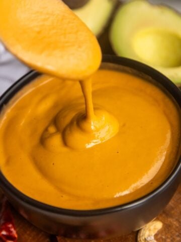 Creamy burrito bowl sauce recipe in a bowl with a spoon.