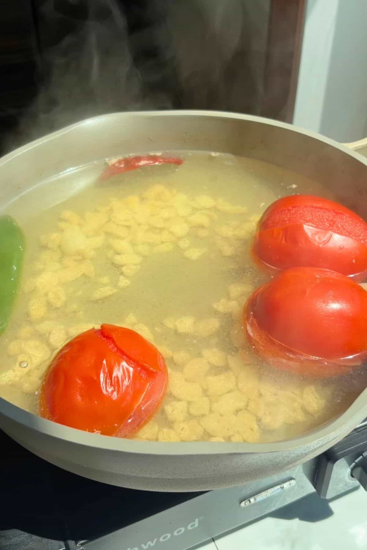 Vegetables boiling in water in a pan.