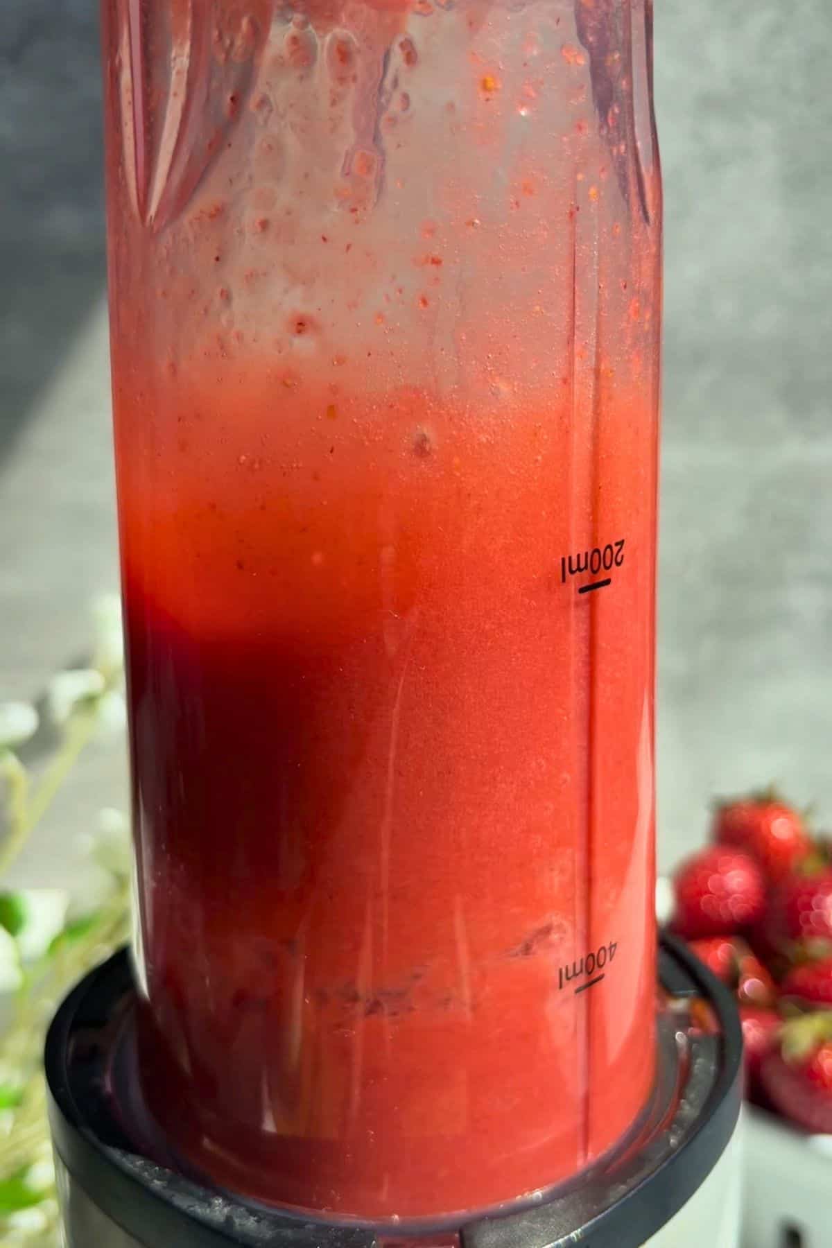 Strawberry puree in a blender blending.