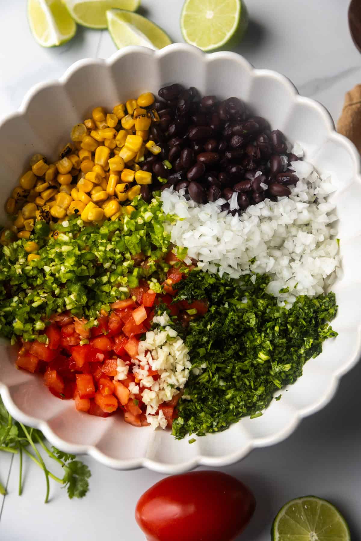 Ingredients for black bean and corn salsa dip in a bowl before mixing.