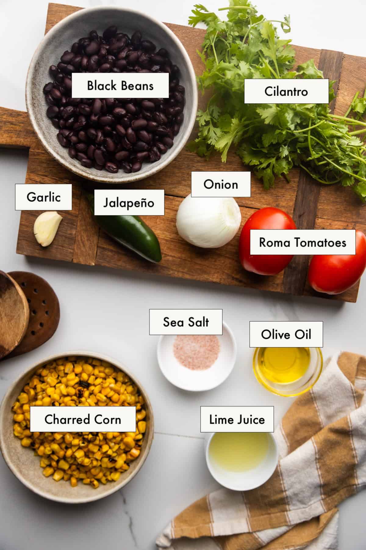 Ingredients for black bean and corn salsa dip laid out on a counter.