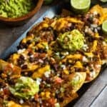 Easy vegan loaded nachos recipe served on a comal.