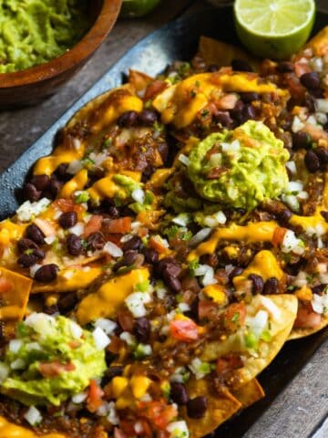 Easy vegan loaded nachos recipe served on a comal.