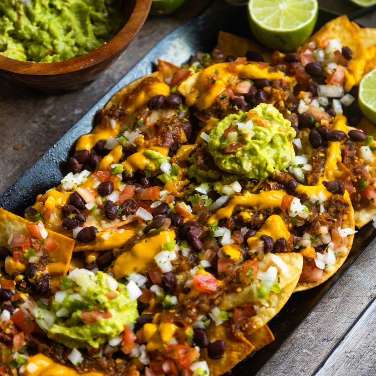 Easy vegan loaded nachos recipe served on a comal.