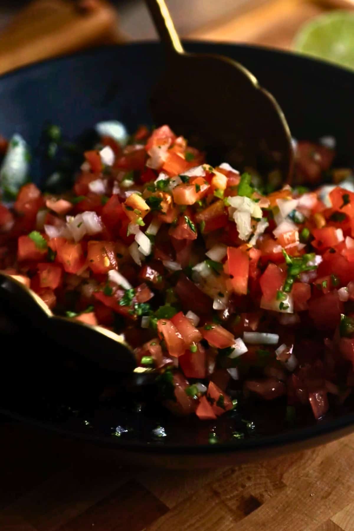 Pico de gallo being made in a bowl.